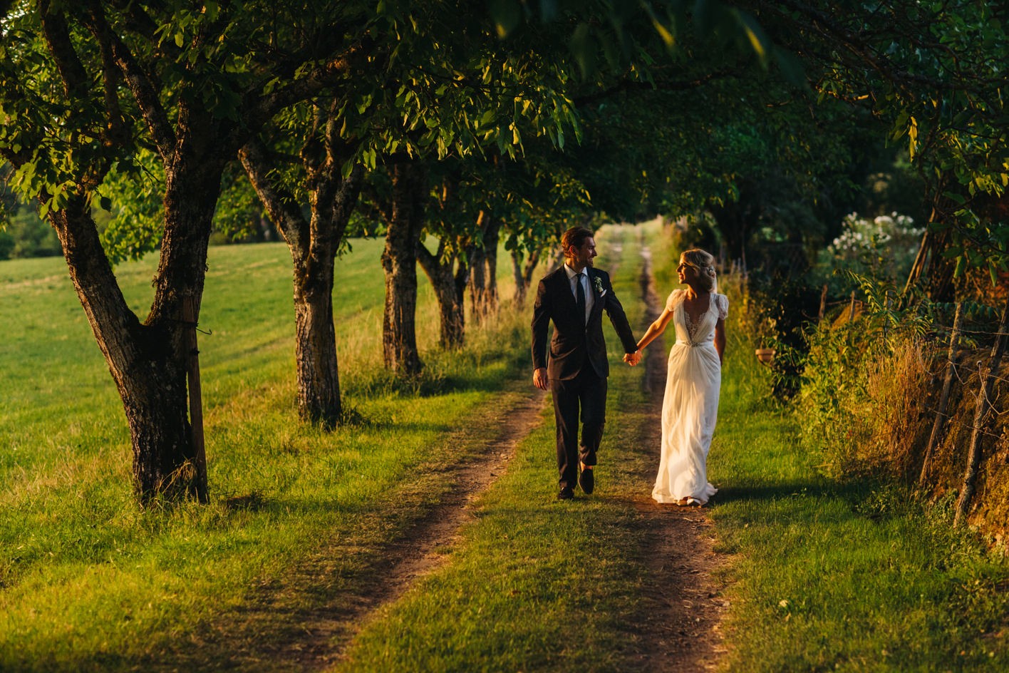 Sunset photographs down lawned driveway at wedding in South west France