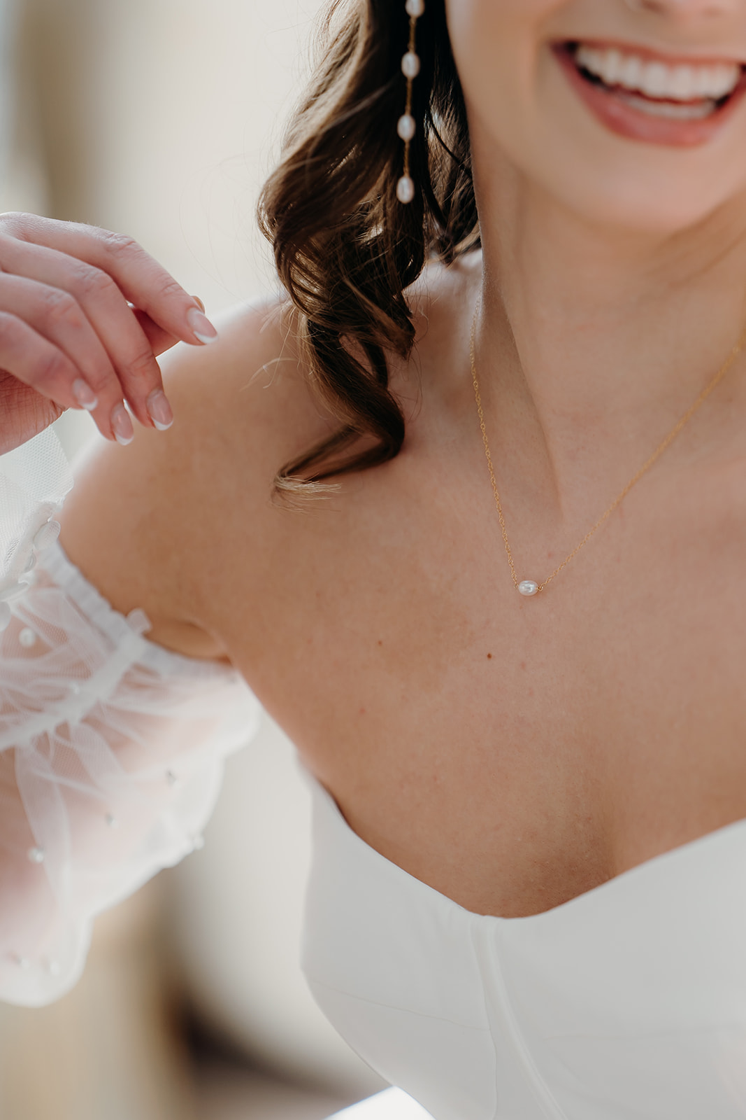 Close up details of kiri and belle jewellery on bride