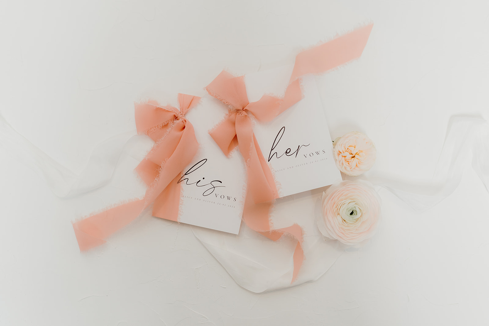 His and hers vow books in peach tones