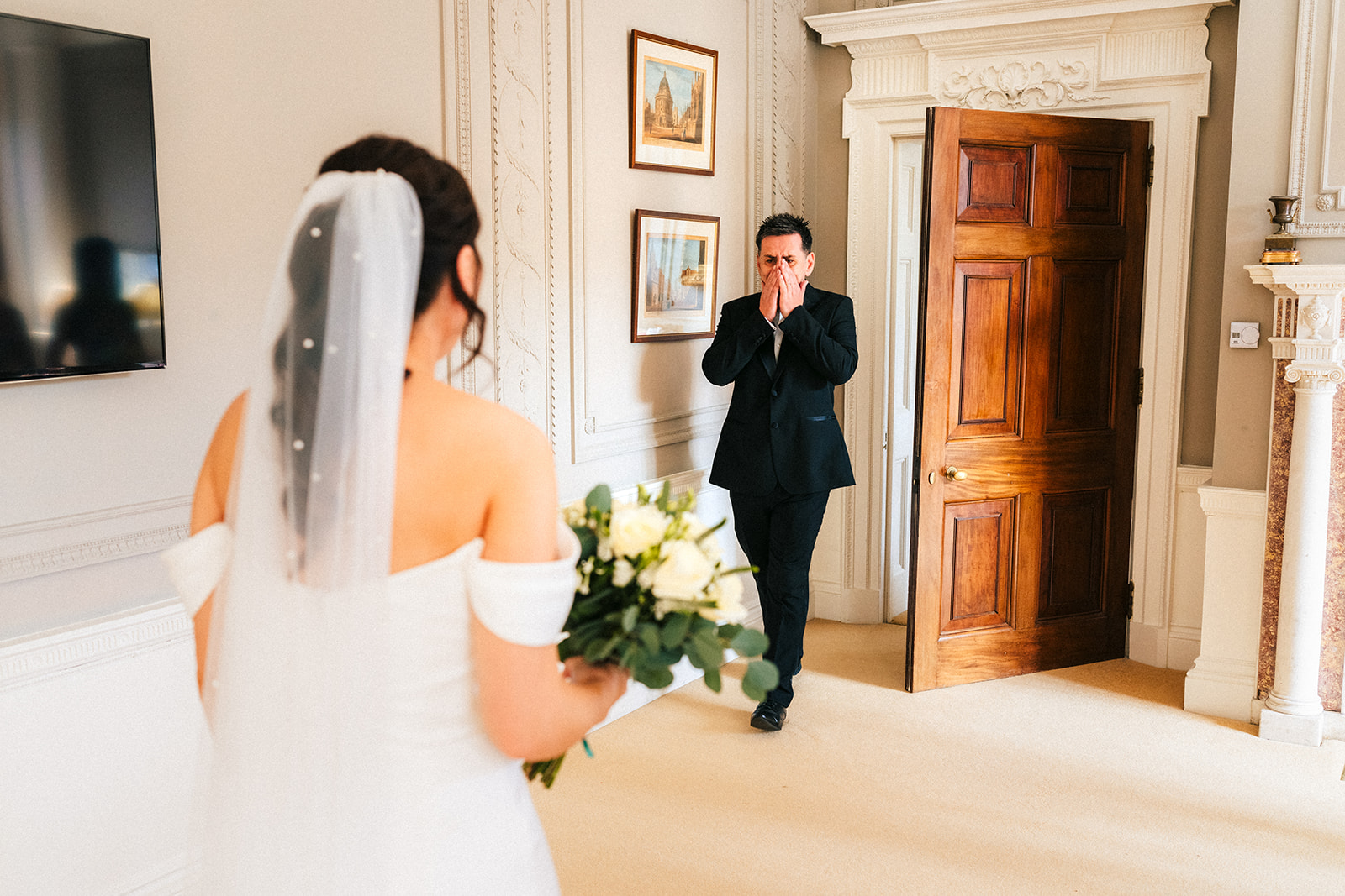 an emotional dad seeing his daughter for the first time in her wedding dress on the morning of her wedding at Rushton Ha