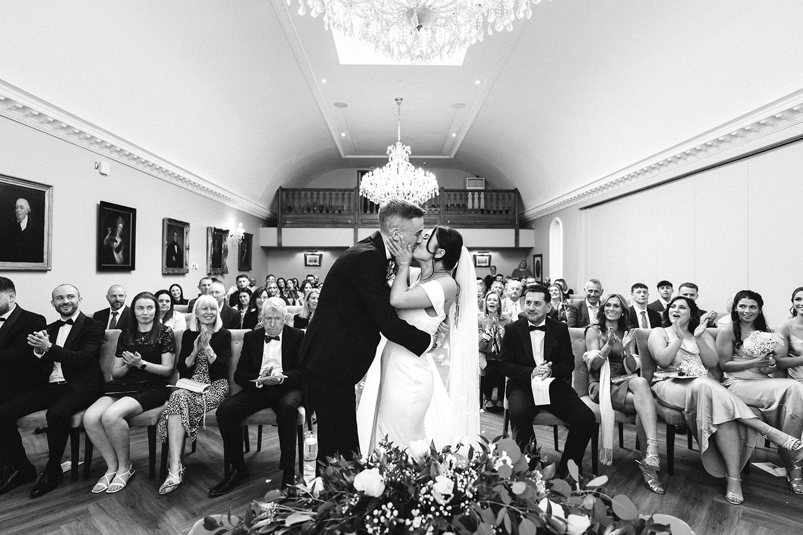 bride and groom kiss after their wedding ceremony at Rushton Hall