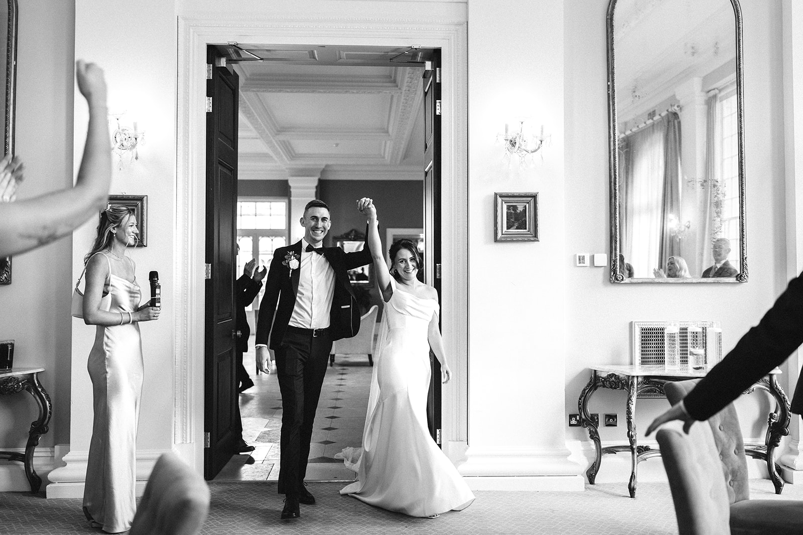 bride and groom enter the wedding breakfast room at Rushton Hall